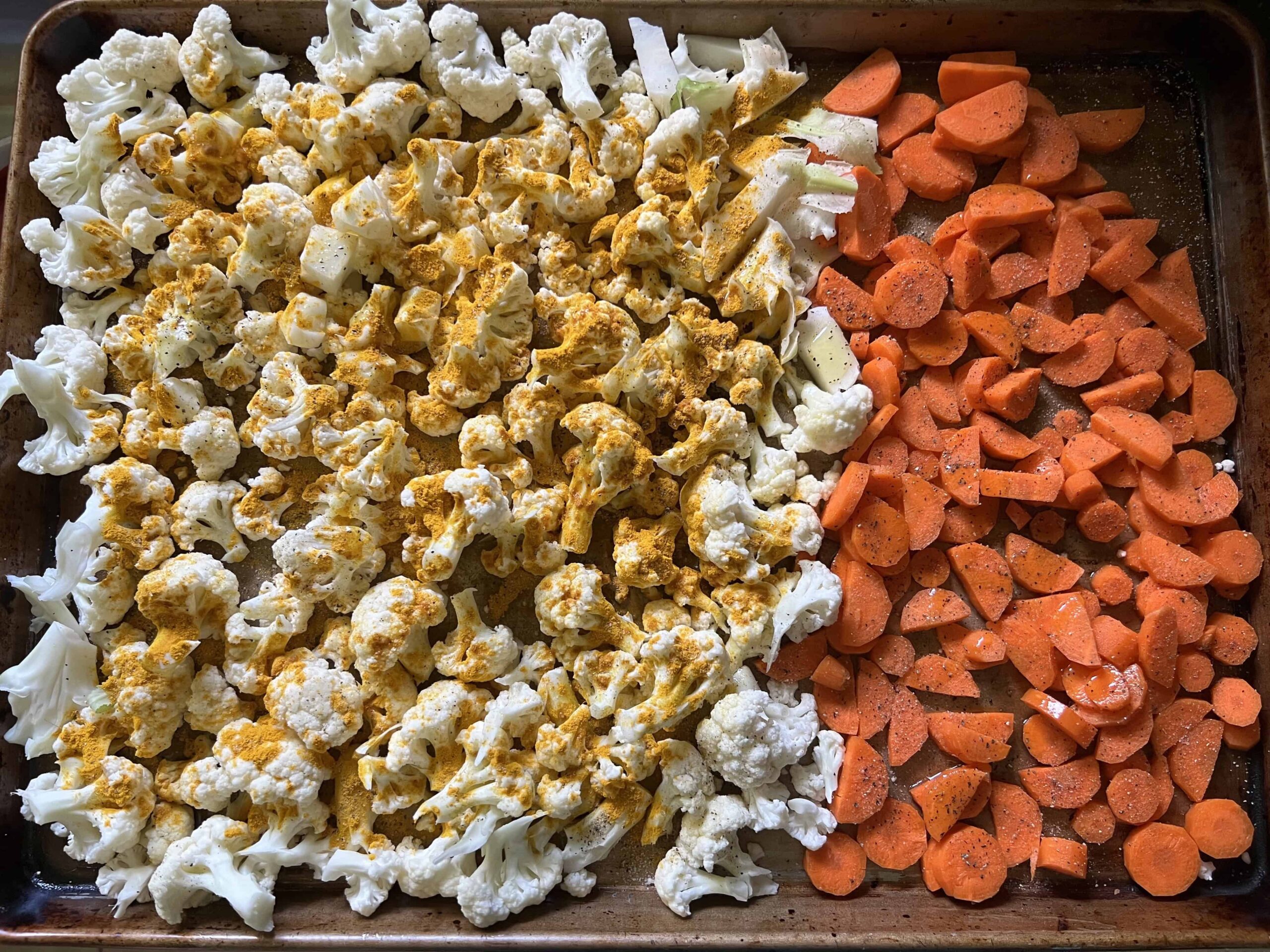 Seasoned vegetables on baking sheet