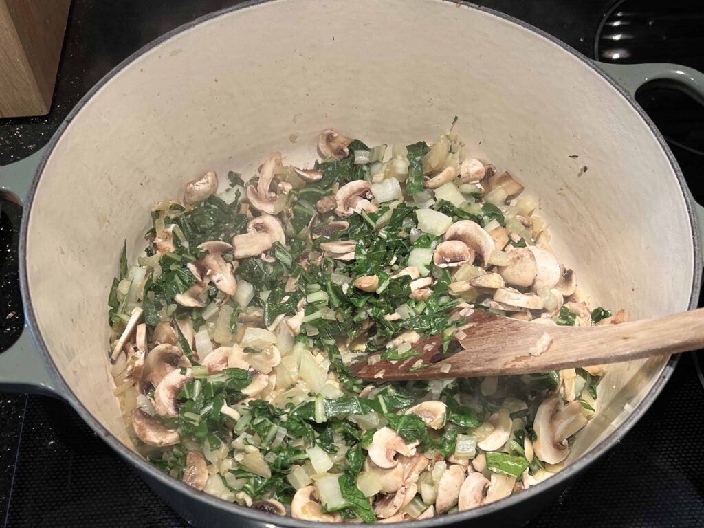 Onion, garlic, bok choy and mushrooms cooking