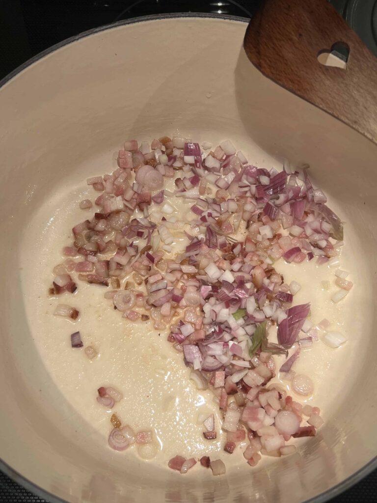 Onions, garlic and bacon in a pot