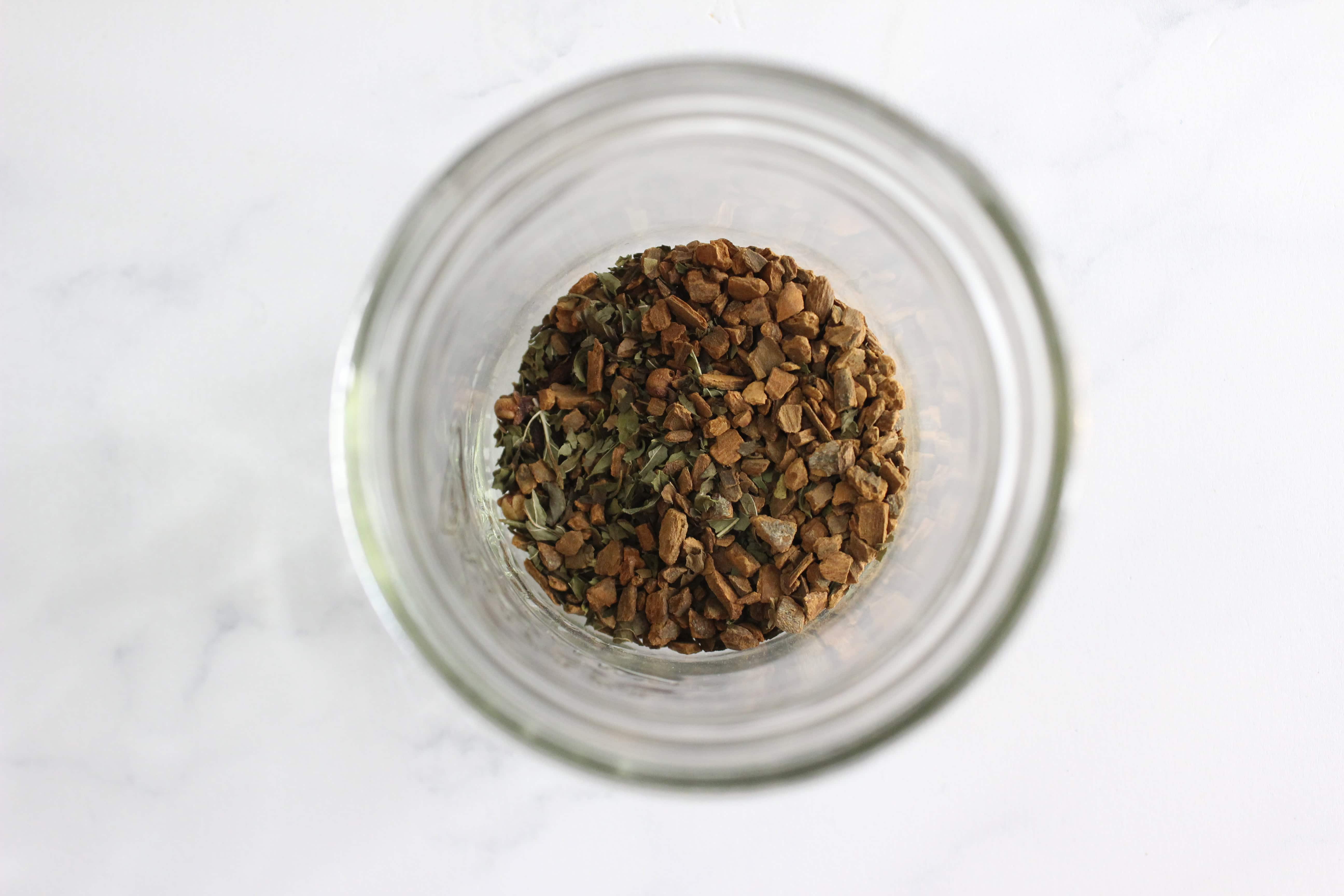 cloves and peppermint in a glass jar