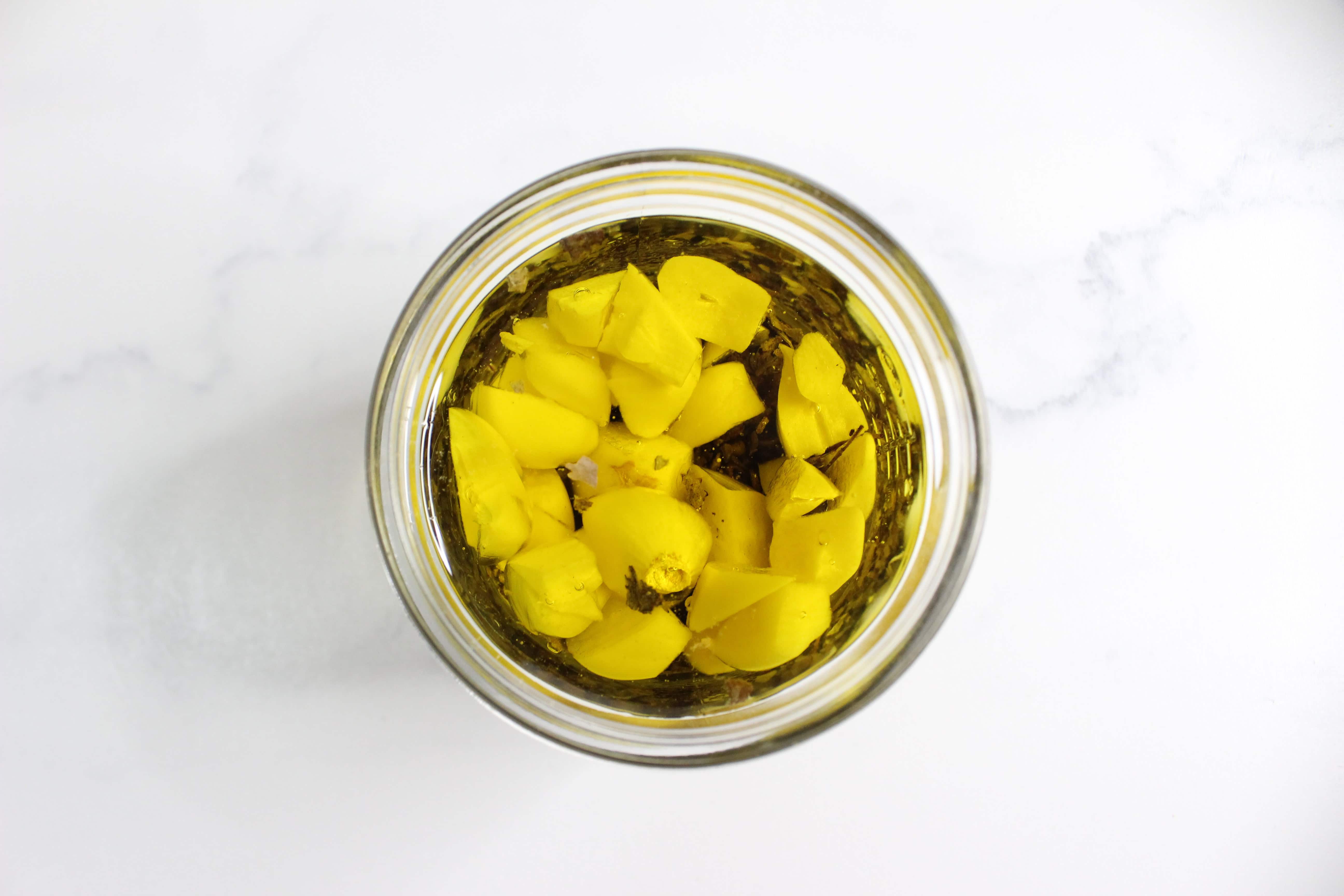 Garlic pieces and dried mullein in a glass jar