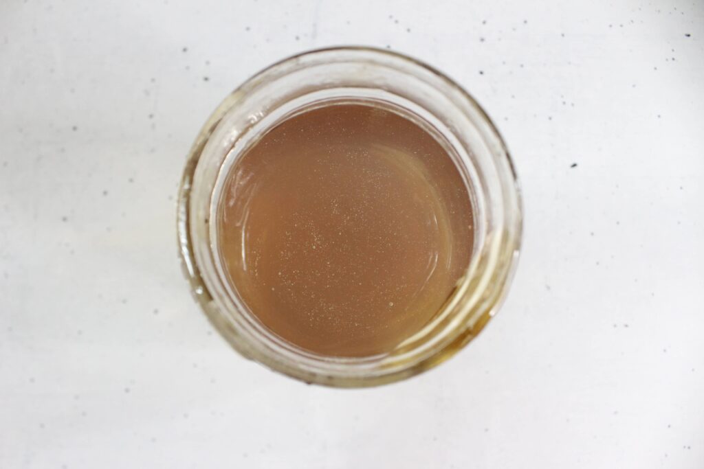 honey and pine needle extract in a glass jar